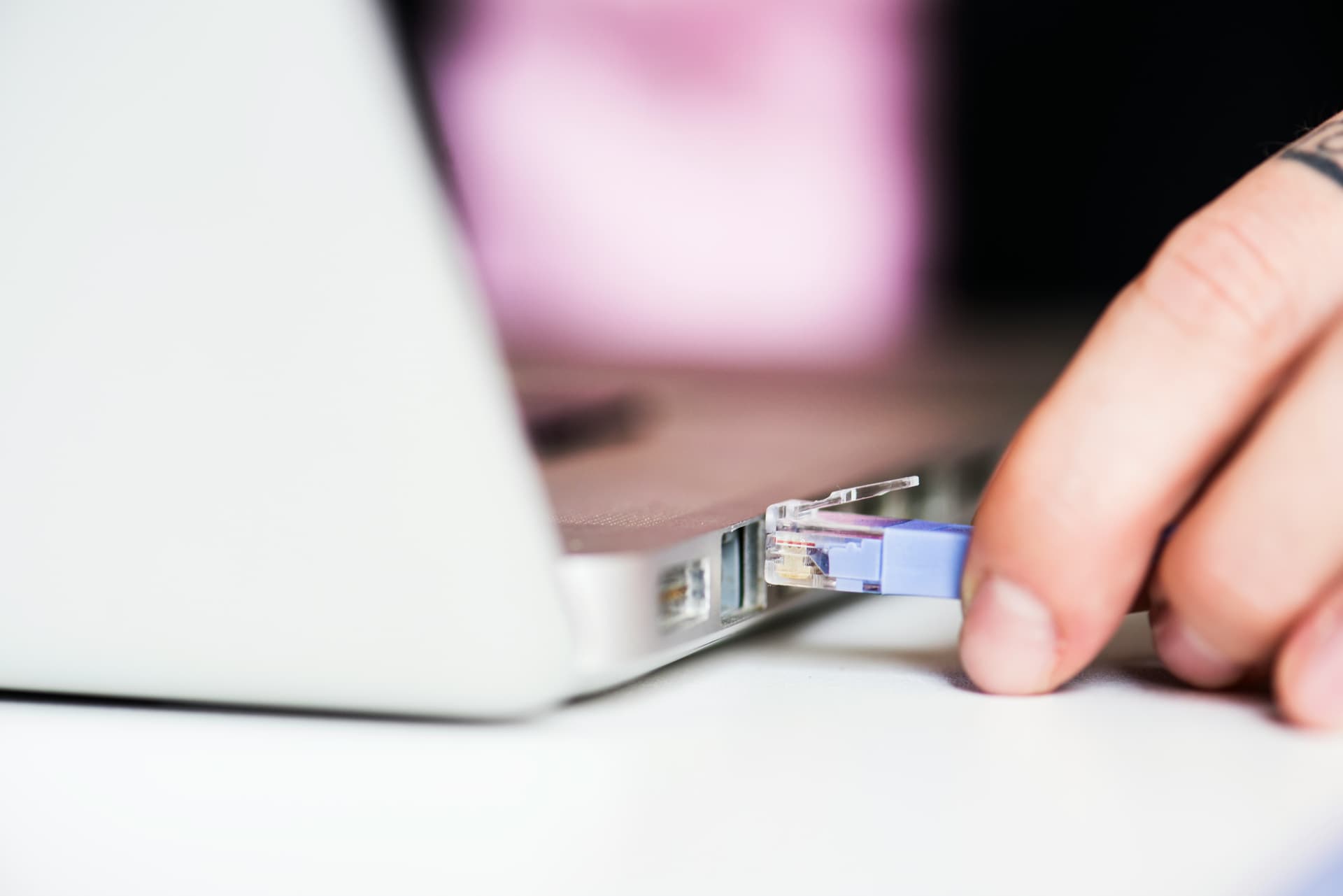 Person working privately on a laptop in low light